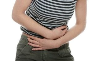 Woman with stomach issues isolated on white background