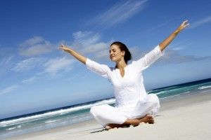 Woman meditating at beach